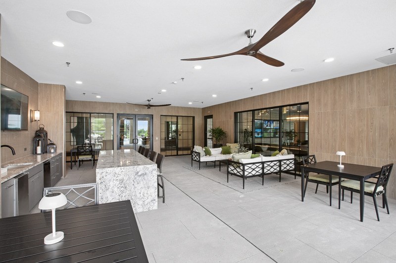 A modern dining room with a black table and chairs.