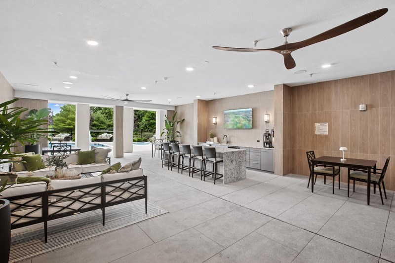 A modern outdoor dining area with a table set for six.