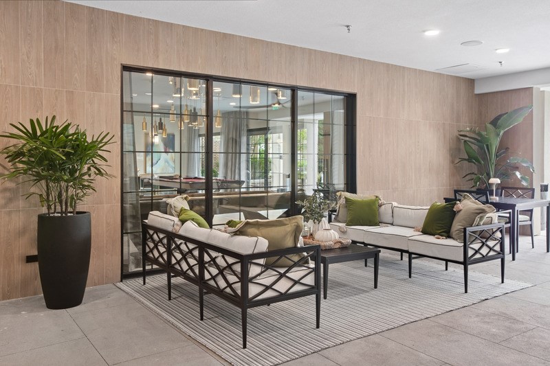 A modern outdoor seating area with a glass door.