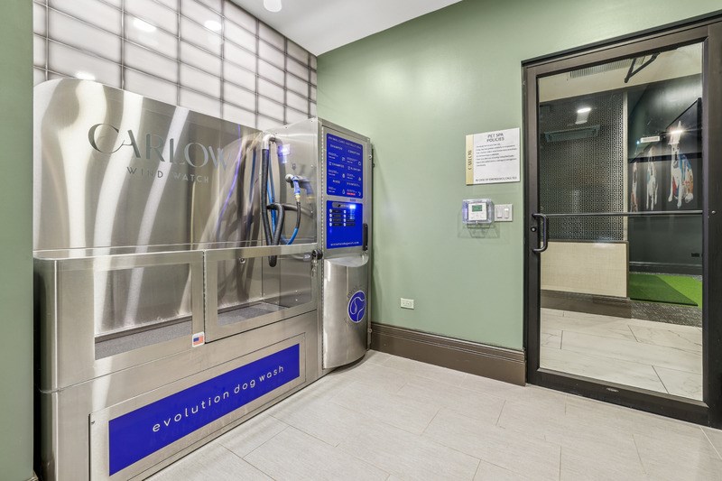 A modern dog wash station with a blue sign that reads "evolution dog wash".