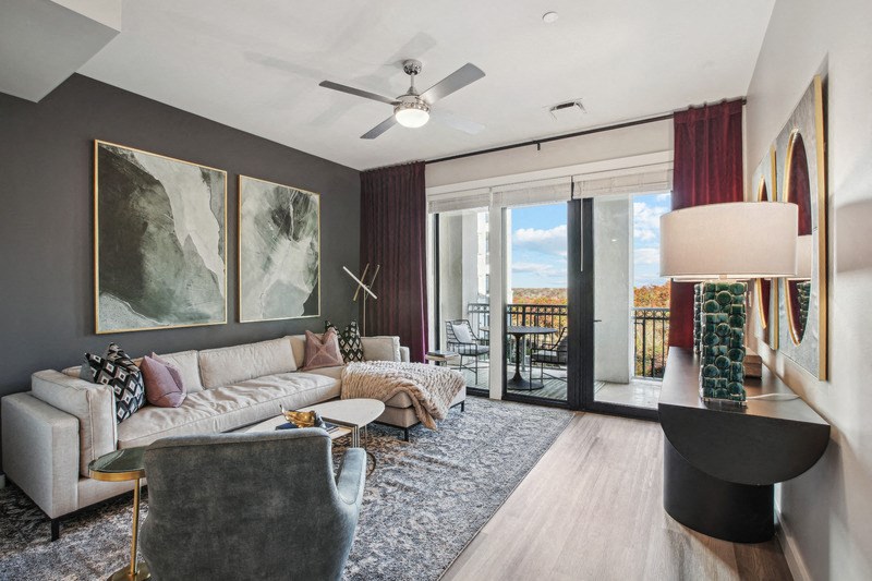 a living room with a couch and chair and sliding glass doors