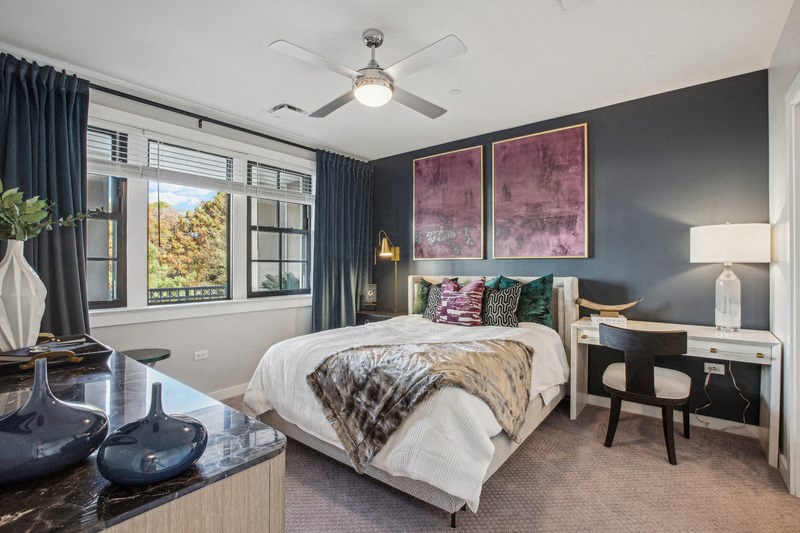 a bedroom with a bed and a ceiling fan