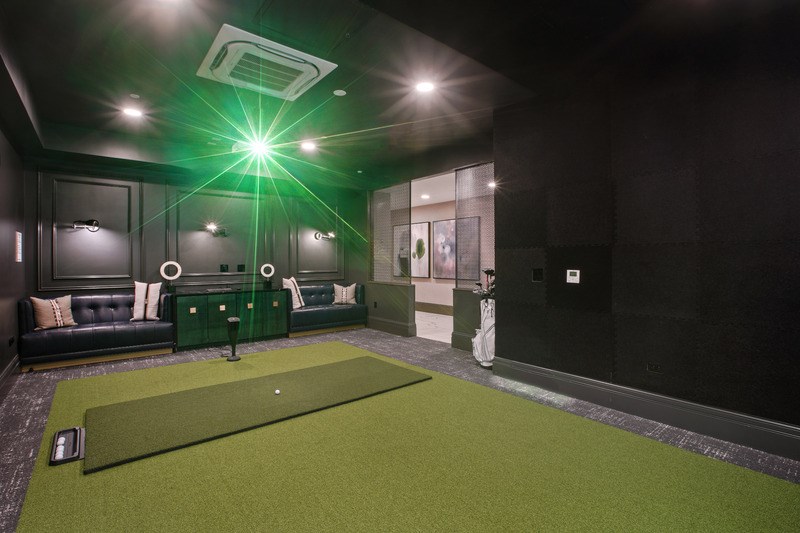 A room with a green carpet and a green light.