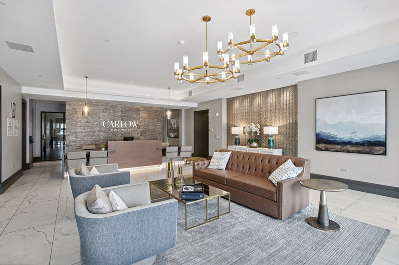 A modern living room with a sofa, chairs, and a coffee table.