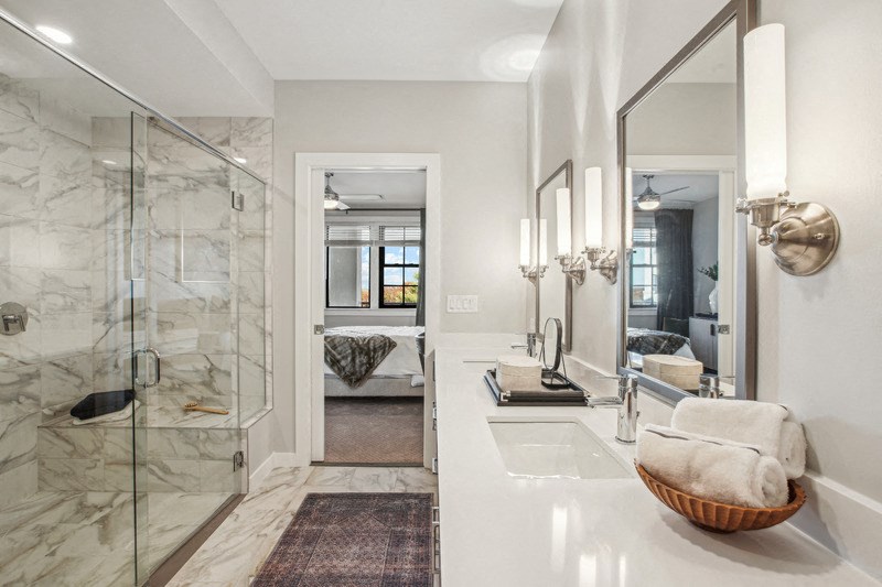 a bathroom with a shower and a sink and a mirror