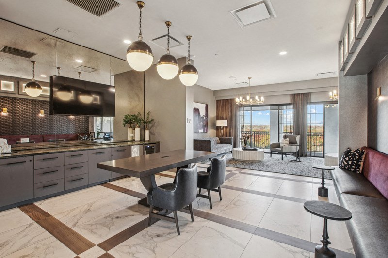 a kitchen and living room with a table and chairs