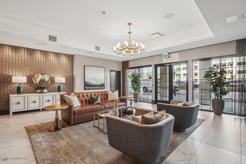 a living room with couches and chairs and a chandelier