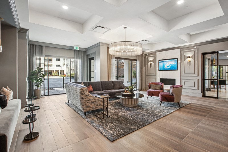 a living room with couches and chairs and a fireplace