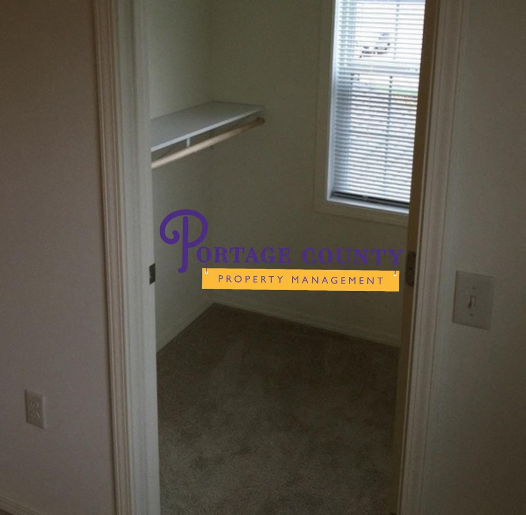 a view of a hallway with a closet and a window