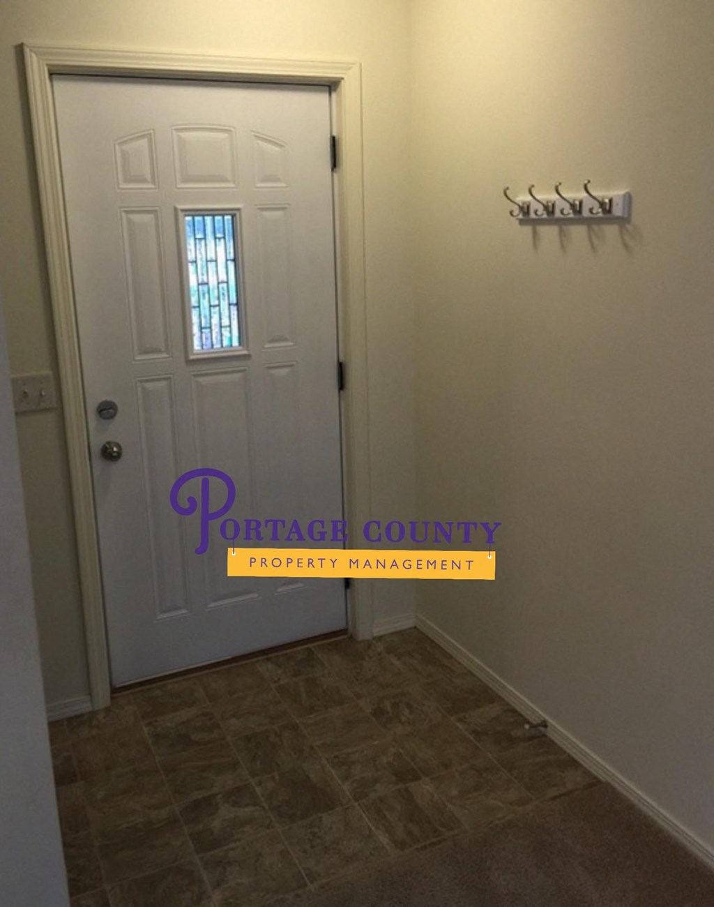 a room with a white door and a door way to a closet