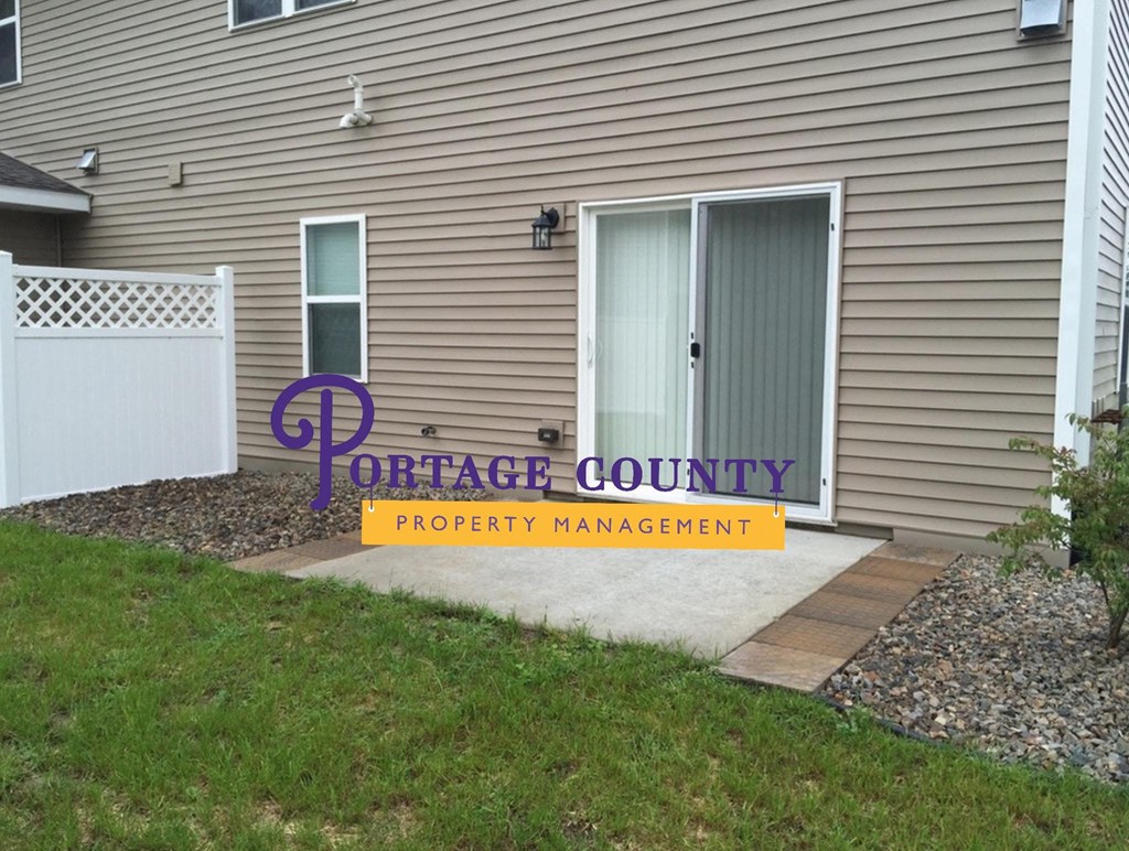a house with a porch county property management sign in front of it