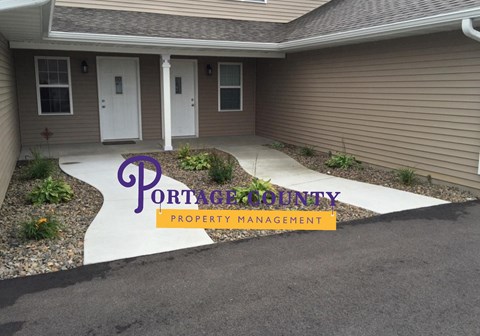 a home with a front porch with a sign that says portage county property management