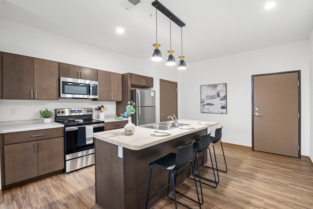 A kitchen with a table and chairs in the middle of the room.