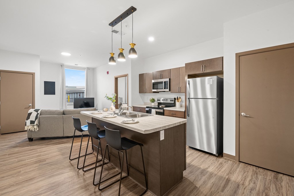 A modern kitchen with a dining table and chairs.