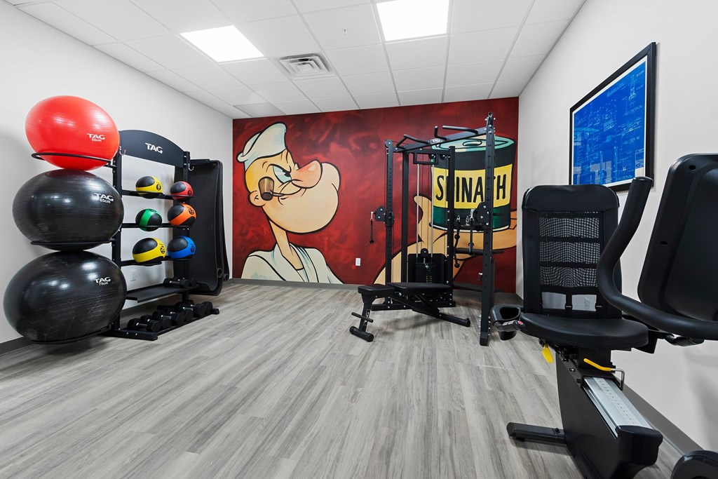 A gym with a large painting of Santa Claus on the wall.