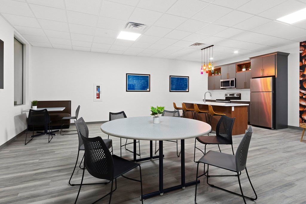 A modern dining room with a round table and chairs.