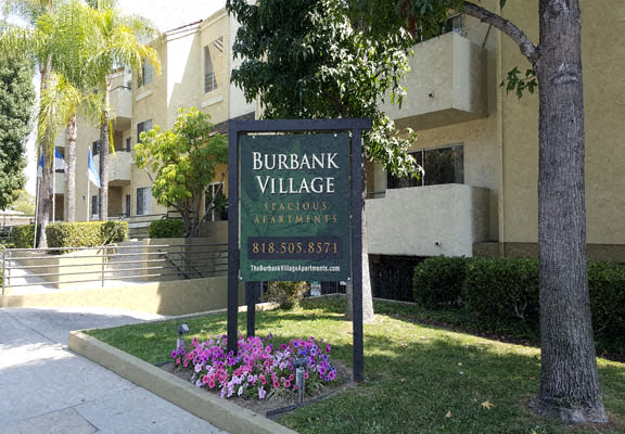 a sign for burbank village in front of an apartment building