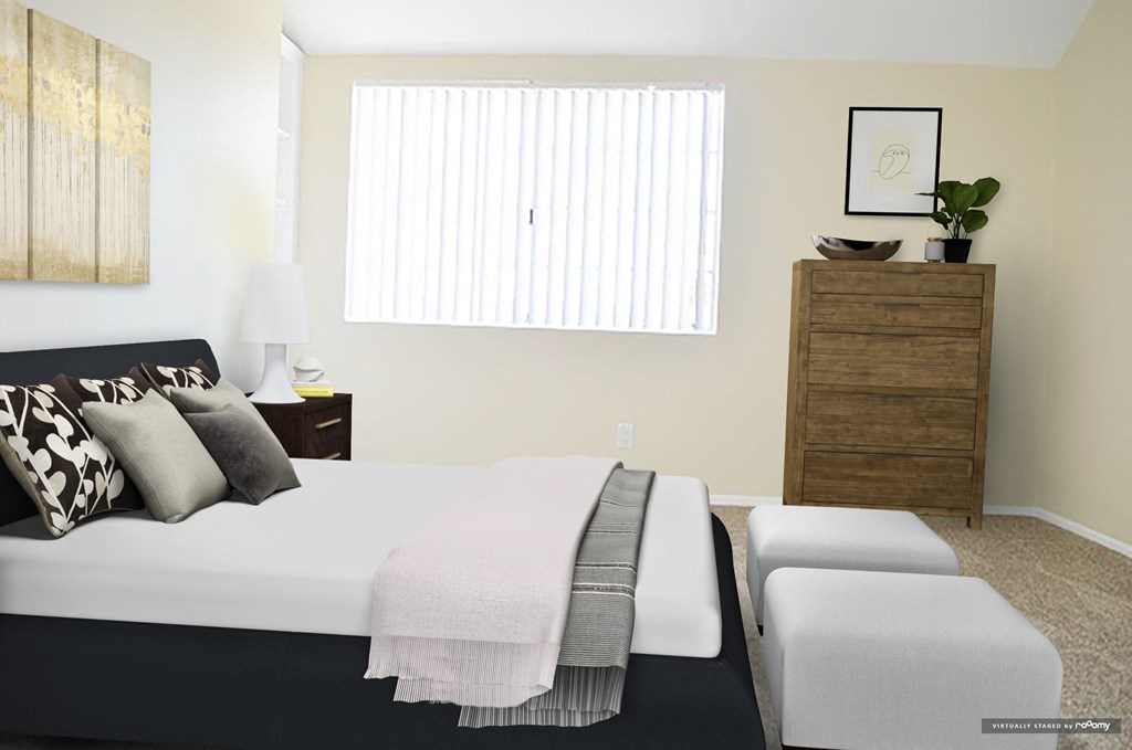 a bedroom with a bed and a dresser and a window