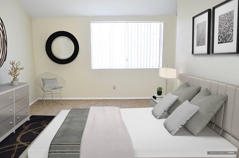 a bedroom with a white bed and pillows