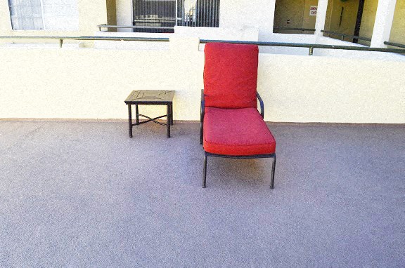 a red chair sitting next to a table