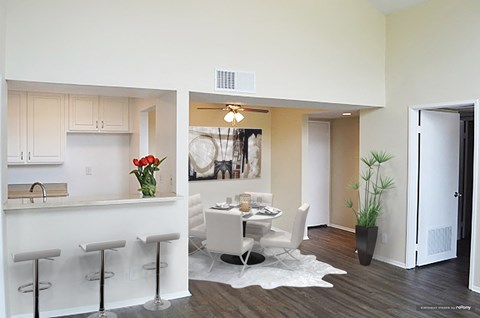 a dining room and kitchen with a table and chairs
