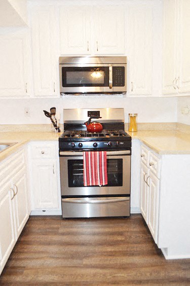 a kitchen with a stove and a microwave