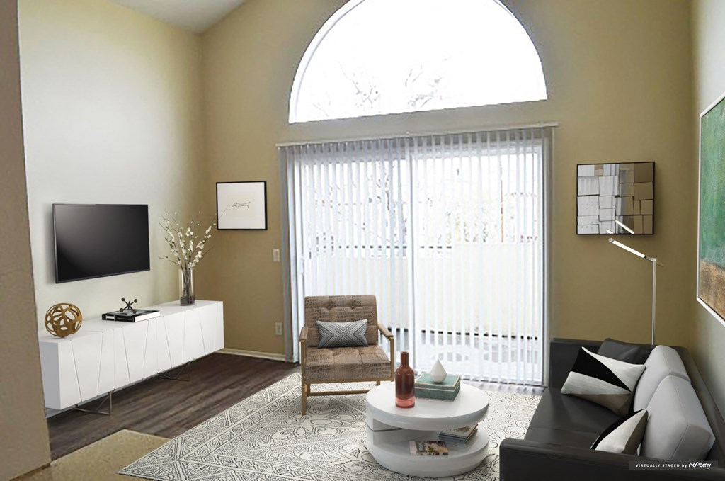 a living room with a large window and a couch and a table