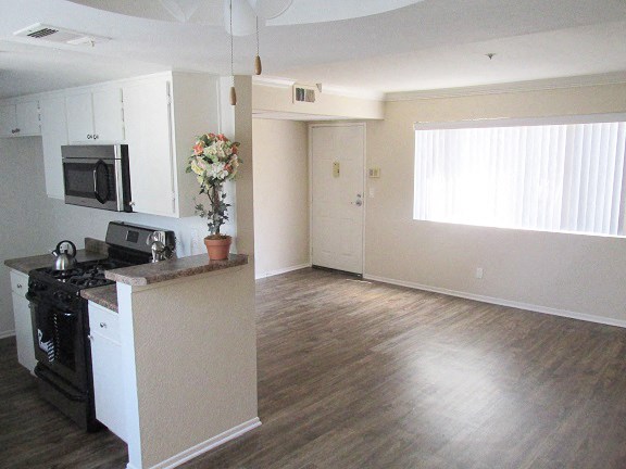 an empty kitchen with a stove and a microwave