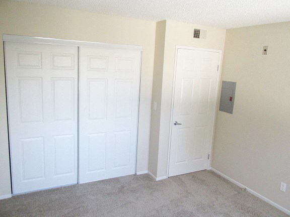 a room with two white doors and a carpeted floor