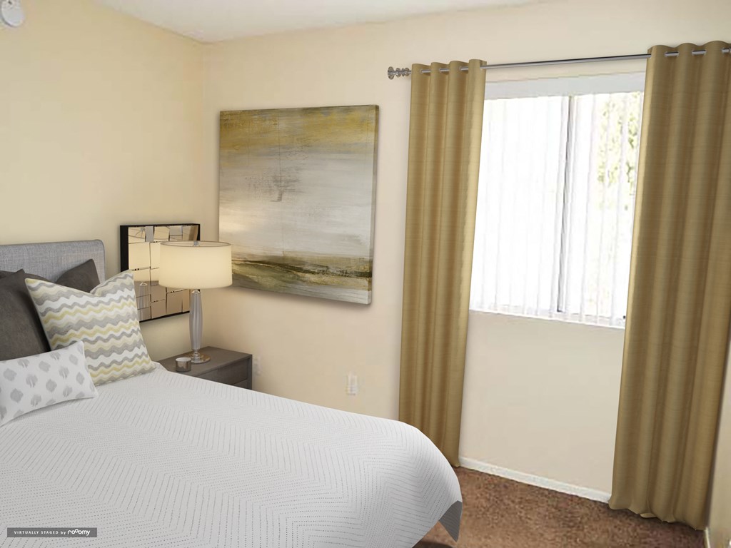 a bedroom with a bed and a window with curtains