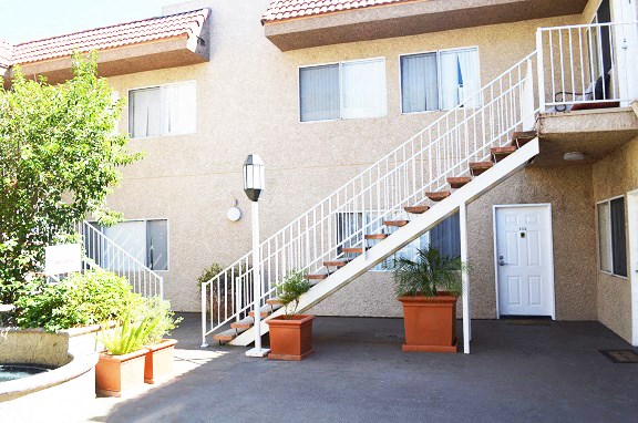 the stairs to the entrance of an apartment building