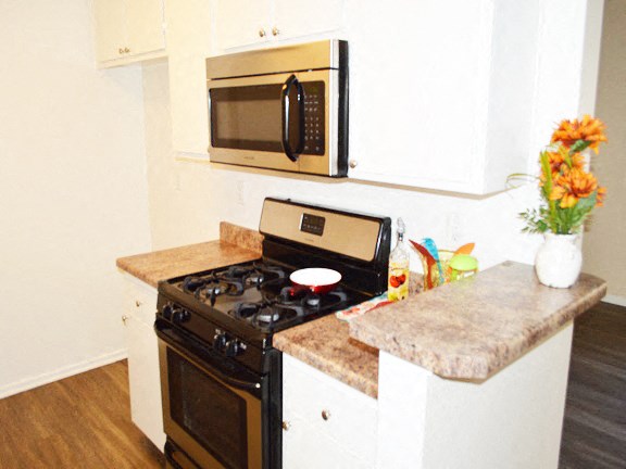 a kitchen with a stove and a microwave