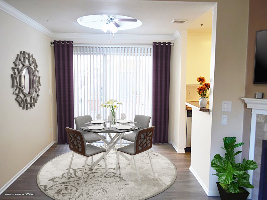 a dining room with a table and chairs and a large window