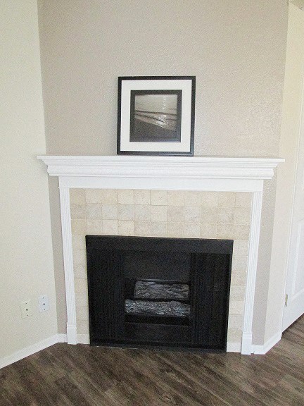 a fireplace in a living room with a picture above it