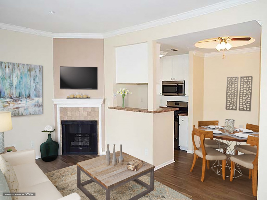 a living room with a fireplace and a dining table