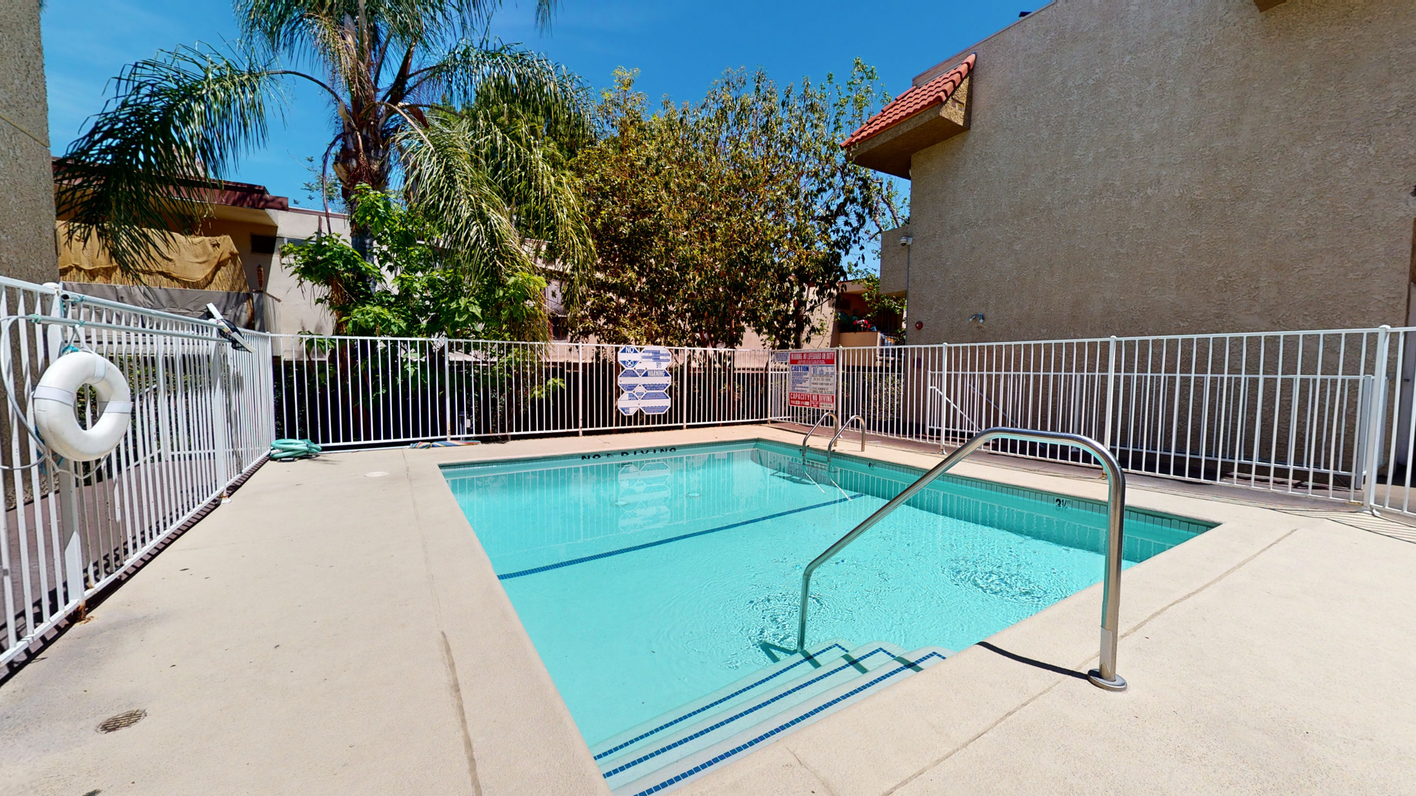 A small pool with a metal fence around it.
