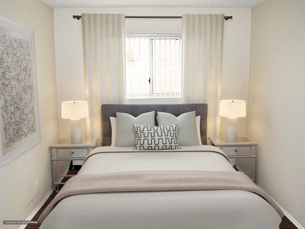 a bedroom with a large bed and a window