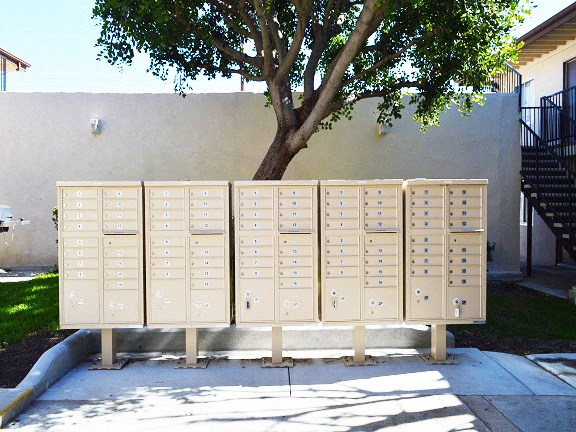 a group of mailboxes sitting in front of a wall