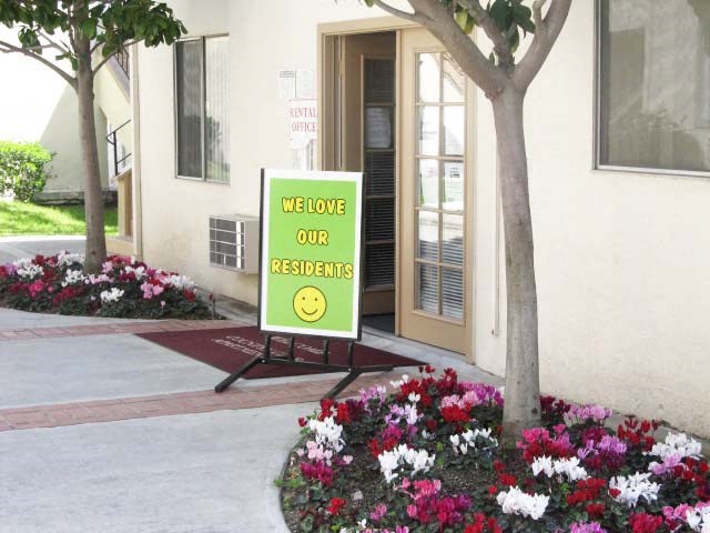 a sign in front of a building that says welcome our residents