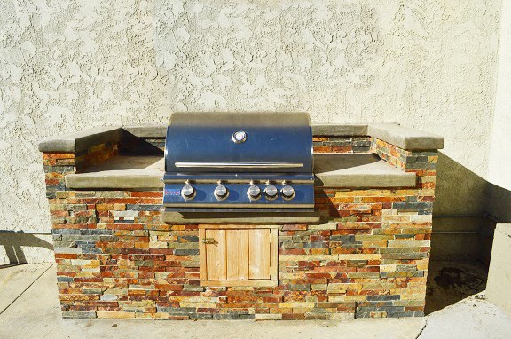a grill on top of a brick wall