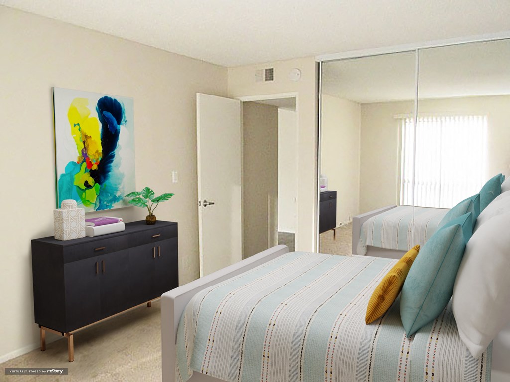 a bedroom with a bed and a mirror