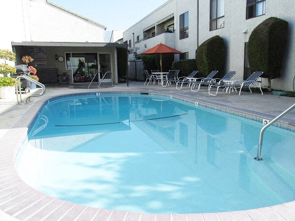 a large swimming pool in front of a building