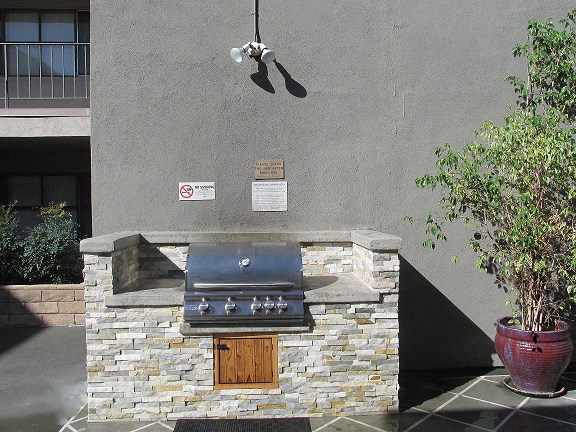 a barbecue grill in front of a building