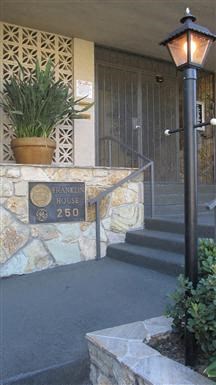 the front of a building with a lamp and stairs