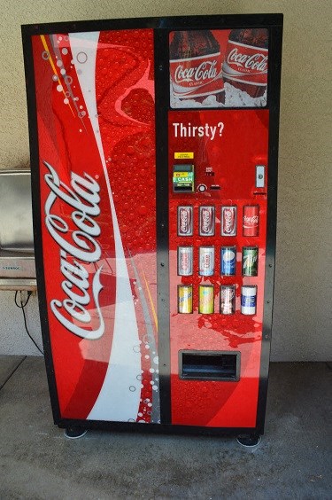 a coca cola vending machine with soda and other beverages
