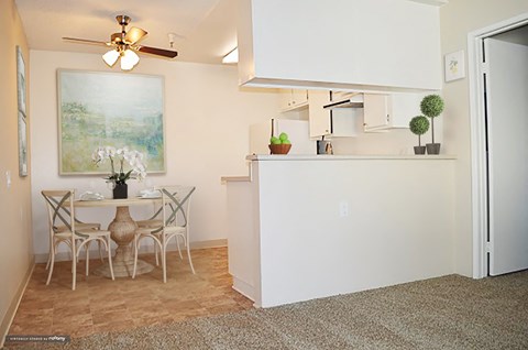 an open kitchen and dining room with a table and chairs