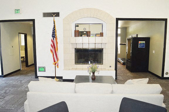 a living room with a white couch and a flag