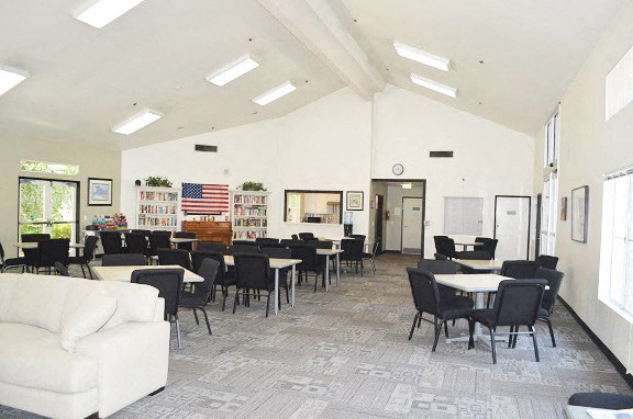 a dining room with tables and chairs and a couch