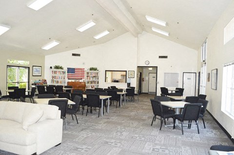 a dining room with tables and chairs and a couch
