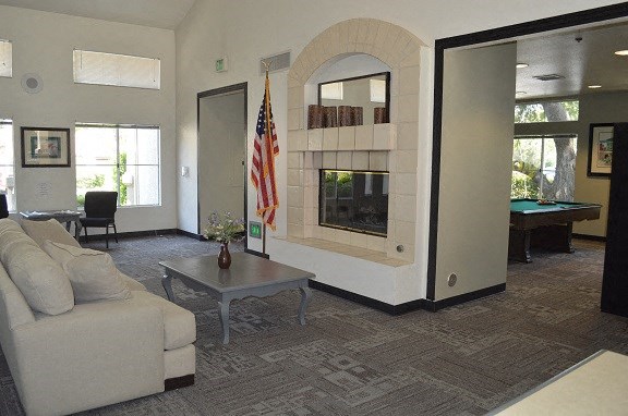 a living room with a couch and a pool table